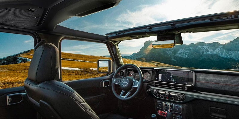 Interior of Jeep Wrangler with mountain view outside